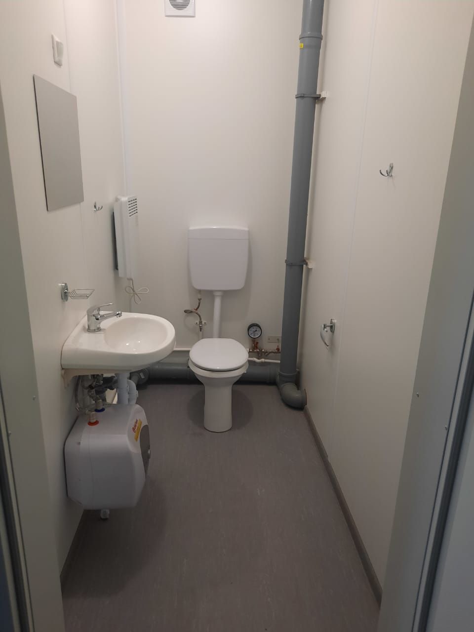 Sanitary block in a modular building — toilet, sink, water heater